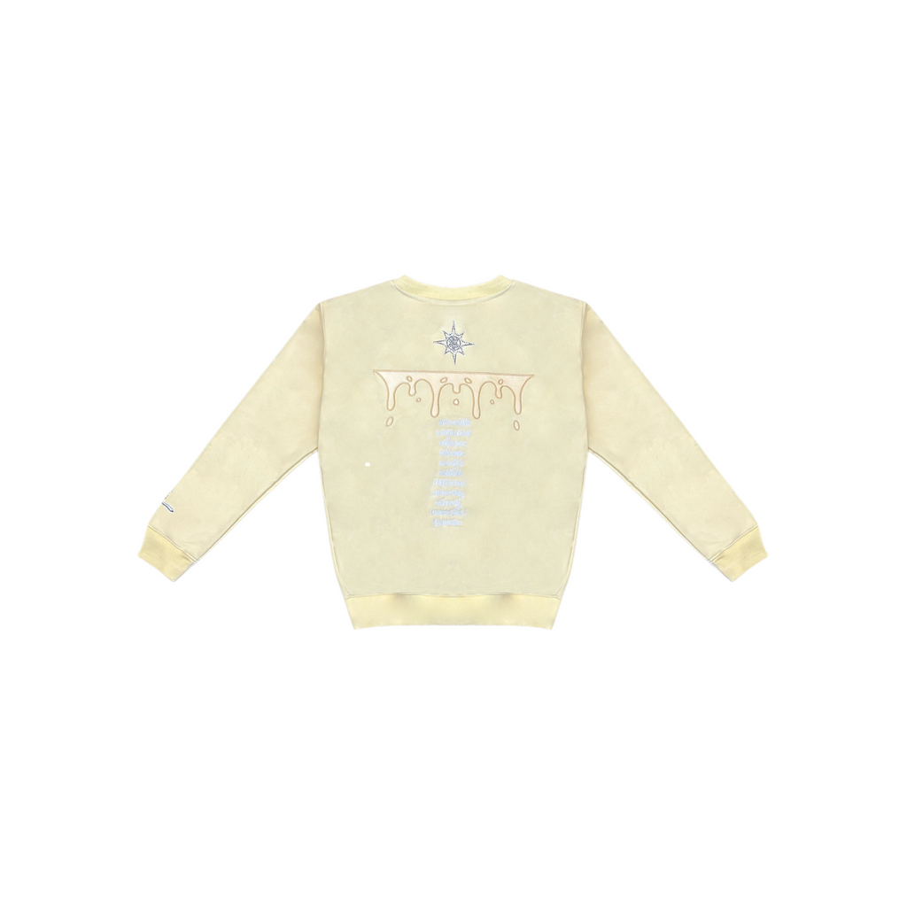 Light yellow sweater with a design on the back against a white background